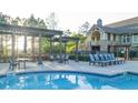 A resort style community pool features a pergola covered lounge area and clubhouse at 237 Laurel Vista Dr, Canton, GA 30114