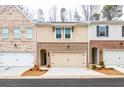 Brick townhome exterior with attached garage and landscaping at 3305 Cranston Ln, Kennesaw, GA 30144