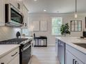 Modern kitchen with white and gray cabinets and herringbone backsplash at 3305 Cranston Ln, Kennesaw, GA 30144