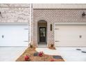 Front entry of townhome with brick facade and arched entryway at 3305 Cranston Ln, Kennesaw, GA 30144