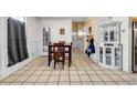 Small dining area with tile floor, wooden table and chairs, and white cabinet at 5392 Brickleberry Way, Douglasville, GA 30134