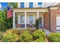 Charming front porch with white columns and American flag at 253 N Gwinnett St, Buford, GA 30518