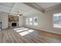 Spacious living room with hardwood floors, a stone fireplace, and a coffered ceiling at 4453 Eastbrook Pl, Snellville, GA 30039