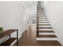 Elegant hardwood staircase with white risers and railing at 1072 Heyward Way, Alpharetta, GA 30009