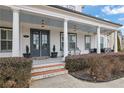 Inviting front porch with classic columns, cozy seating, and stylish gray accents for a welcoming entrance at 3177 Capriole Dr, Marietta, GA 30062