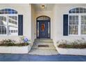 House entrance with dark blue door, stone steps, and white columns at 1260 Lakehaven Pkwy, Mcdonough, GA 30253