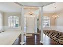 Spacious living room with hardwood floors, white columns, and a chandelier at 1260 Lakehaven Pkwy, Mcdonough, GA 30253