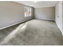 Spacious bedroom with gray walls and carpet flooring at 978 Gwens Sw Trl, Lilburn, GA 30047