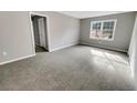 Bright bedroom featuring gray walls and carpeted floors at 978 Gwens Sw Trl, Lilburn, GA 30047