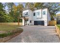 Modern farmhouse style home with a paved driveway and fenced yard at 156 Martha Ne Ave, Atlanta, GA 30317