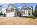 Lovely home with stone and siding exterior, featuring a two-car garage and well-maintained front yard at 173 Mill Creek Dr, Canton, GA 30115