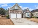 Attractive home with a stone facade, a two-car garage, and a nicely landscaped front yard at 173 Mill Creek Dr, Canton, GA 30115