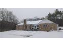 Stone house exterior in winter setting with snow on the ground at 650 Kingston Highway, Kingston, GA 30145