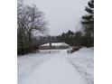 Long driveway leading to stone house covered in snow at 650 Kingston Highway, Kingston, GA 30145