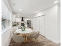 Cozy dining area featuring a round table, four chairs, and natural light, next to the modern kitchen at 1288 Almont Sw Dr, Atlanta, GA 30310