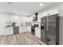 Modern kitchen featuring stainless steel appliances, granite countertops, subway tile backsplash, and white cabinets at 1288 Almont Sw Dr, Atlanta, GA 30310