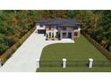 Luxury home with driveway, landscaping, and a fenced yard at 1349 Oak Rd, Lilburn, GA 30047