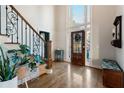 Light-filled foyer featuring hardwood floors, staircase with wrought iron, and a striking front door with transom windows at 1701 Crowes Lake Ct, Lawrenceville, GA 30043