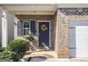 Charming front door entry with wreath and landscaping at 10954 Wheeler Trce, Hampton, GA 30228