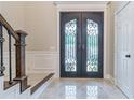 Elegant entryway with double doors and a marble floor at 235 Ridge Bluff Ln, Suwanee, GA 30024