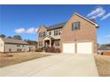 Two-story house with a two-car garage and driveway at 3849 Sweet Iris Cir, Loganville, GA 30052