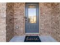 Gray front door with a glass insert and a welcome mat at 404 Discovery Ln, Ellenwood, GA 30294