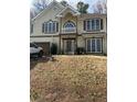 Front view of a two-story house with beige siding and a balcony at 255 Thornbush Ln, Lawrenceville, GA 30046