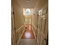 Spacious hallway with hardwood floors, and a large window at the end at 255 Thornbush Ln, Lawrenceville, GA 30046