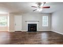 Spacious living room featuring hardwood floors, a fireplace, and a ceiling fan at 2295 Creekview Trl, Decatur, GA 30035