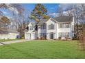 Two-story house with white siding, two-car garage, and a landscaped lawn at 3029 Oakvale Hts, Decatur, GA 30034