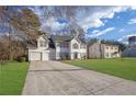 Two-story house with white siding, two-car garage, and a well-manicured lawn at 3029 Oakvale Hts, Decatur, GA 30034