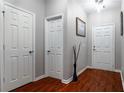 A view down a hallway with hardwood flooring and white doors at 3363 Fernview Dr, Lawrenceville, GA 30044