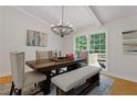 Bright dining room with a wood table, bench seating, and access to a deck at 514 Dogwood Cir, Norcross, GA 30071