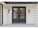 Dark-stained double front doors with sidelights and elegant black accents at 514 Dogwood Cir, Norcross, GA 30071