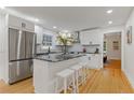 Modern kitchen featuring white cabinets, granite island, and stainless steel appliances at 514 Dogwood Cir, Norcross, GA 30071