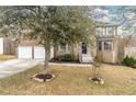 Brick two-story home with a two-car garage and beautiful landscaping at 6834 Fireside Ln, South Fulton, GA 30349