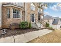 Home front entrance featuring brick facade, black front door, and landscaped front yard at 6834 Fireside Ln, South Fulton, GA 30349