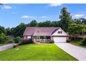 Ranch home with brick facade, attached garage, and a spacious lawn at 144 Bobs Sw Dr, Mableton, GA 30126