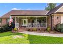 Inviting front porch with rocking chairs and landscaping at 144 Bobs Sw Dr, Mableton, GA 30126