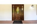 Elegant dark brown front door with a decorative glass window at 3241 Briscoe Rd, Loganville, GA 30052