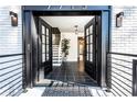 Bright entryway with black double doors and view of staircase at 7715 Ryefield Dr, Sandy Springs, GA 30350