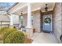 Inviting front porch with seating area and brick columns at 91 Harris St, Buford, GA 30518