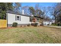 Recently updated home with a white exterior, gray accents and a well-manicured lawn at 2007 North Nw Ave, Atlanta, GA 30318