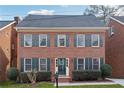 Two-story brick home with green shutters and a well-maintained lawn at 3182 Henderson Walk, Atlanta, GA 30340