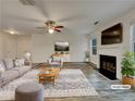 Virtually staged living room with fireplace, hardwood floors, and neutral decor at 129 Baywood Xing, Hiram, GA 30141