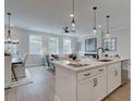 Open concept kitchen with island, white cabinets, and stainless steel appliances at 747 Trevett Way, Marietta, GA 30062