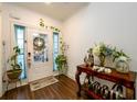 Inviting entryway with hardwood floors, decorated with plants, flowers, and a bright, cheerful ambiance at 3430 Summerpoint Xing, Cumming, GA 30028