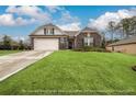 Two-story house with stone accents and a landscaped lawn at 3430 Summerpoint Xing, Cumming, GA 30028