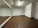 Spacious basement with large mirror, wood flooring, and ample space at 18 Peachtree Ne Ave # 1, Atlanta, GA 30305