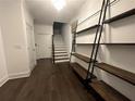 Bright entryway with dark hardwood floors, staircase, and built-in shelving at 18 Peachtree Ne Ave # 1, Atlanta, GA 30305